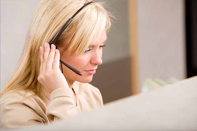 Woman talking with hand on headset
