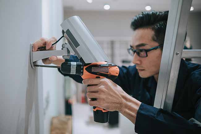 Technician installing security camera